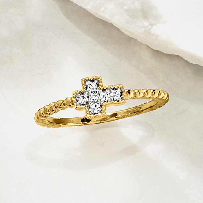 Gold cross diamond-beaded ring viewed from side, showing raised stone cross setting