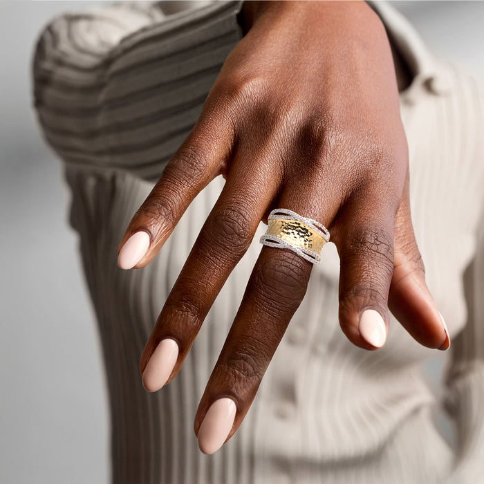 Hammered diamond ring in gold over sterling on a hand