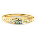 Gold-plated bangle bracelet with blue and white simulated gemstones in a row