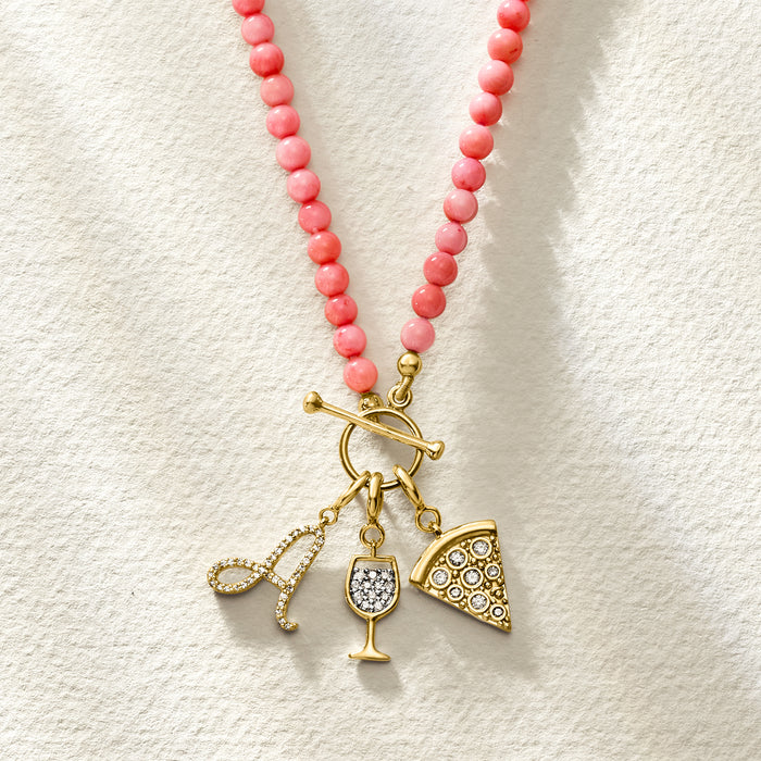 Pizza-slice charm with round white stones on a gold clasp amid pink bead necklace
