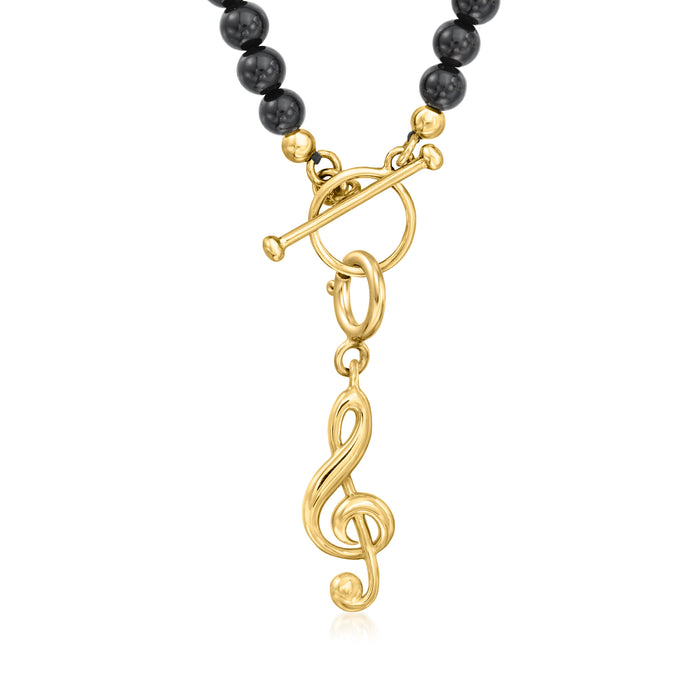 Gold treble clef charm with linked ring and clasp detail