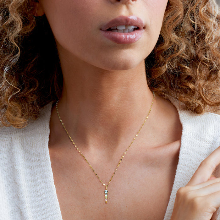 Gold over sterling chain necklace with small vertical gemstone pendant featuring round blue and colored stones