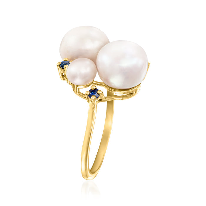 Gold-tone ring with three white pearls, blue sapphire details, slim band
