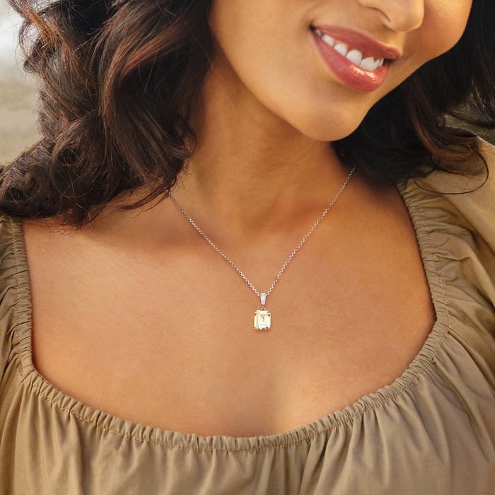 Sterling silver CZ pendant necklace worn on neckline, yellow rectangular center stone