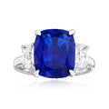 Sterling silver three-stone ring with cushion-cut blue center and clear side stones