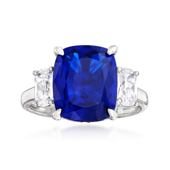 Sterling silver three-stone ring with cushion-cut blue center and clear side stones