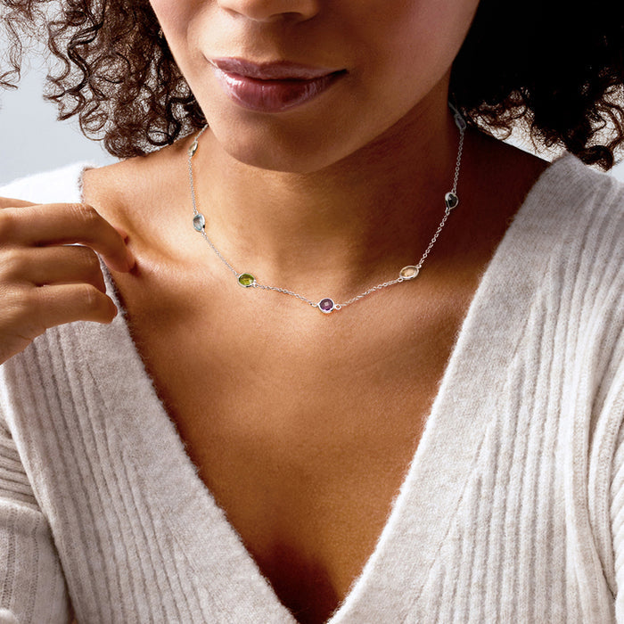 Sterling silver multicolor gem station necklace on the neckline, with small dangling stones