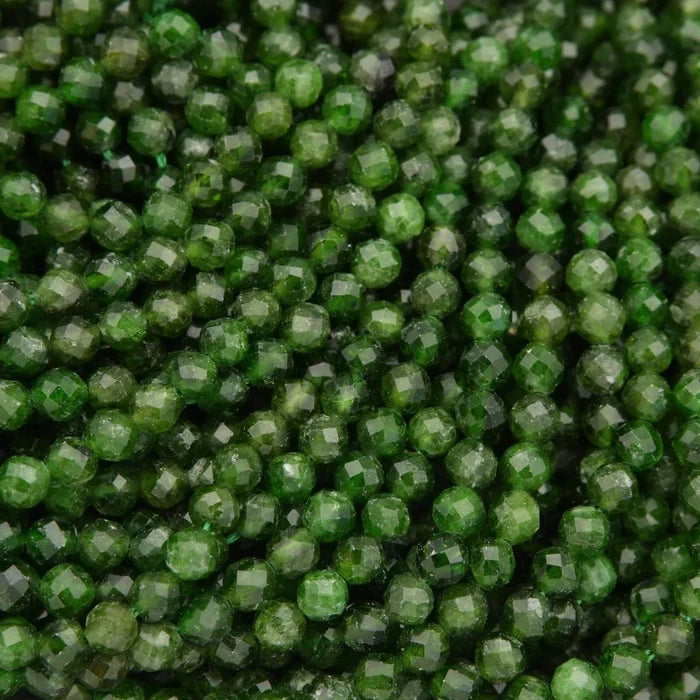 Close-up of green beads with a faceted texture