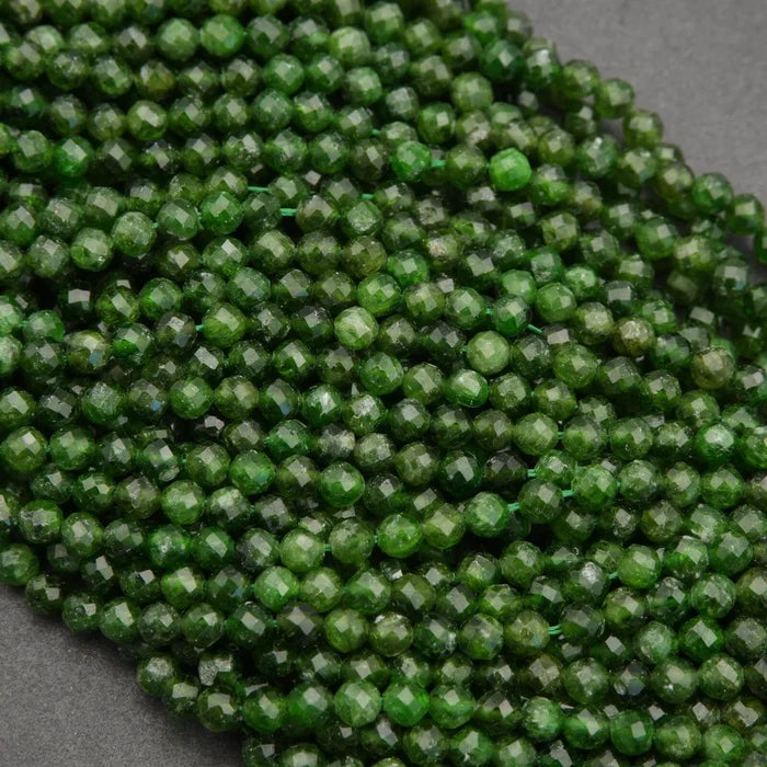 Close-up of green faceted beads on a gray background