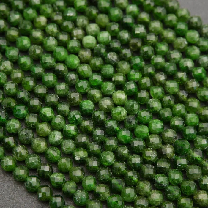 Close-up of green faceted beads on a gray background