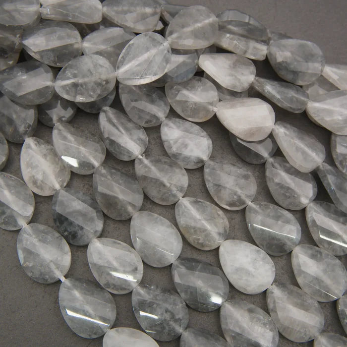 Cloudy clear twisted oval beads.