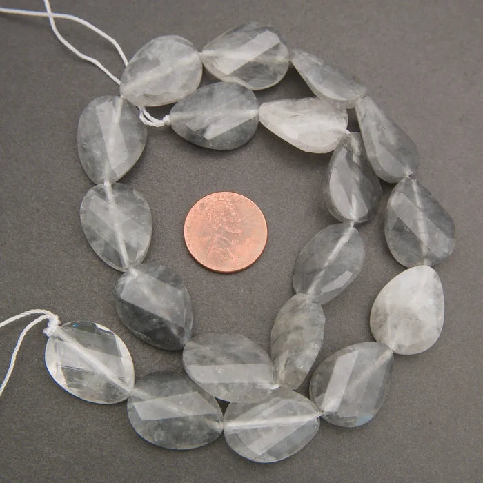 Cloudy clear twisted oval beads.