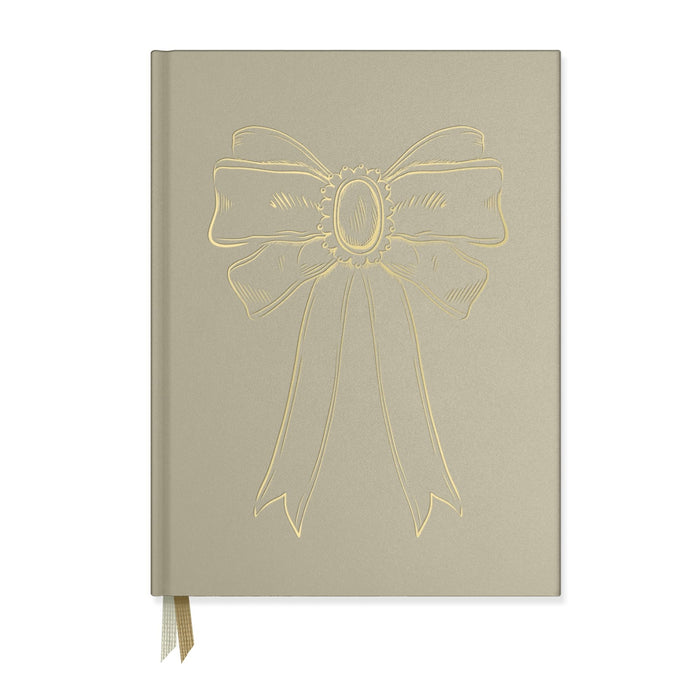 Notebook by Good Juju with gold detailing depicting a bow.