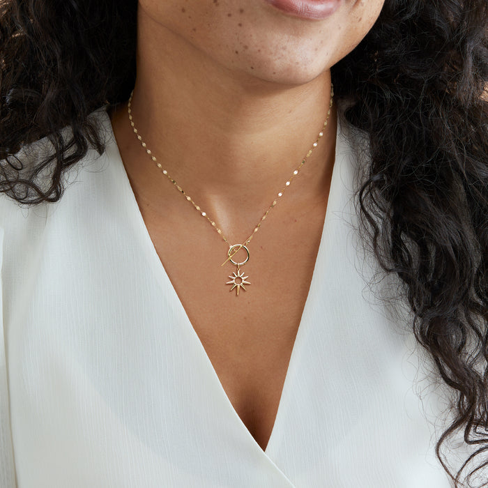14kt yellow gold sun charm pendant on a fine chain necklace