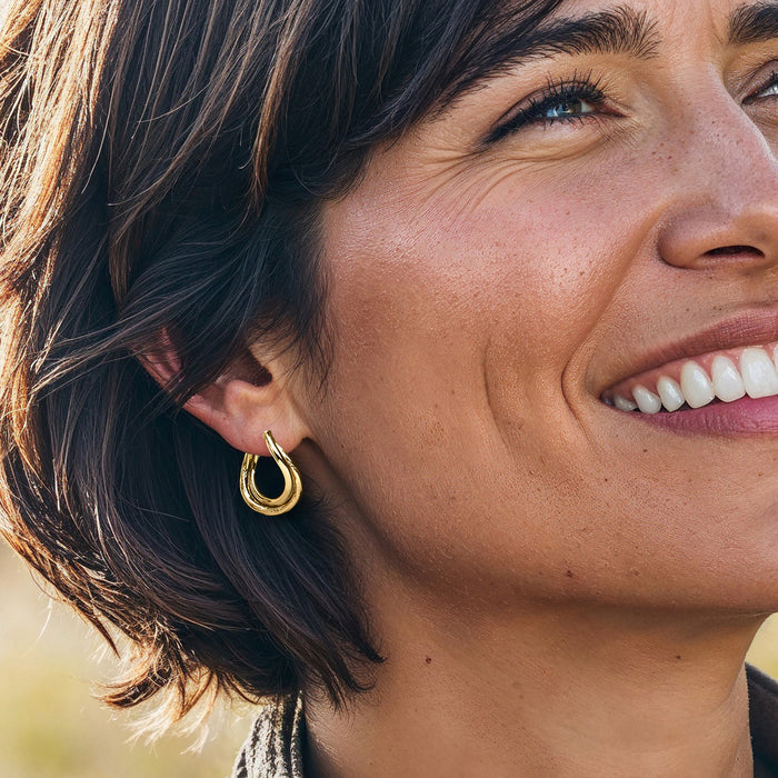 14kt yellow gold twisted double-hoop hoop earrings on ear