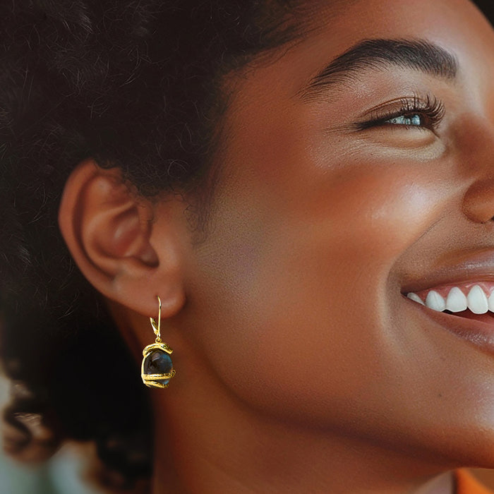 Gold leverback drop earrings with blue labradorite teardrop and small green stone accents