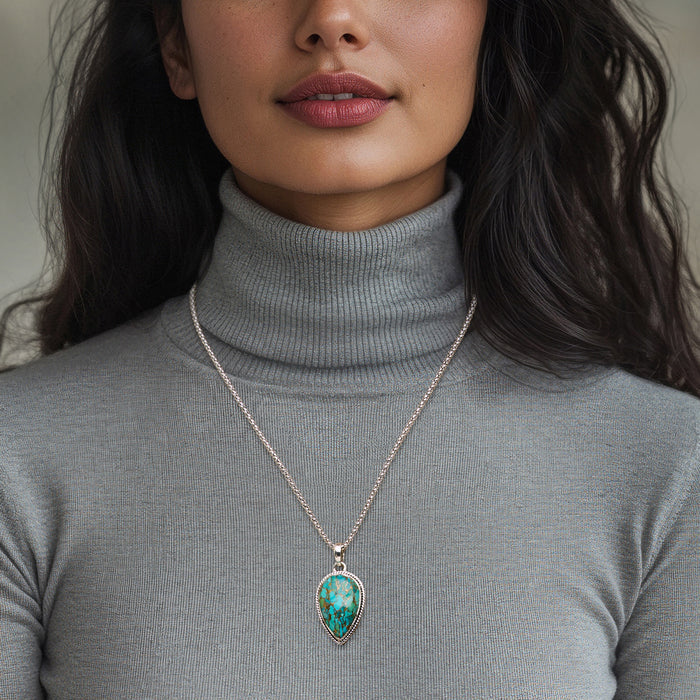 Sterling silver turquoise pear pendant necklace worn on a fine chain
