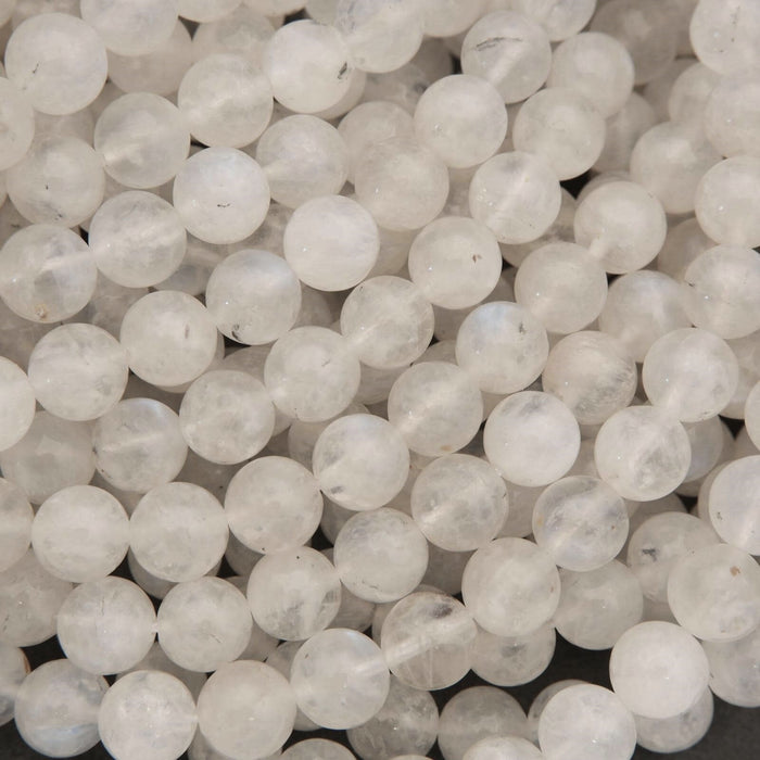 Close-up of white marble beads on a dark background