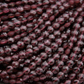 Close-up of dark red beads on a dark background