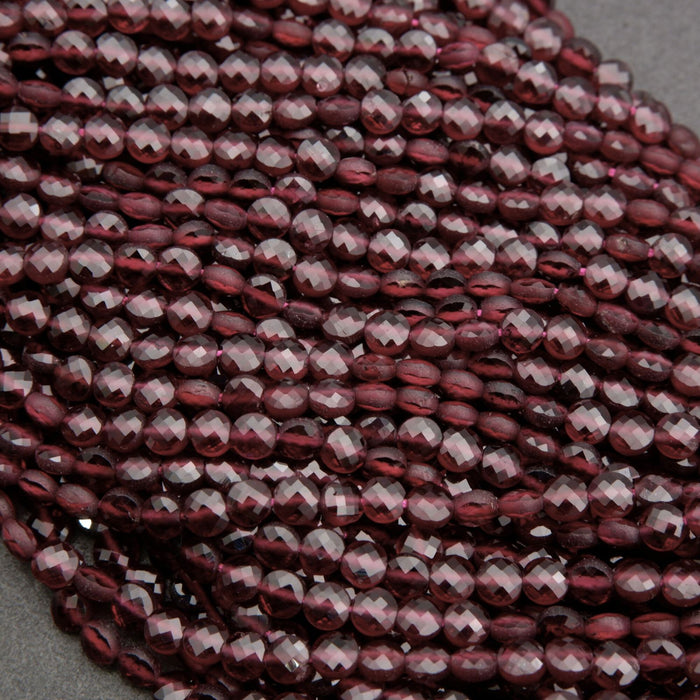 Close-up of faceted red beads on a gray background