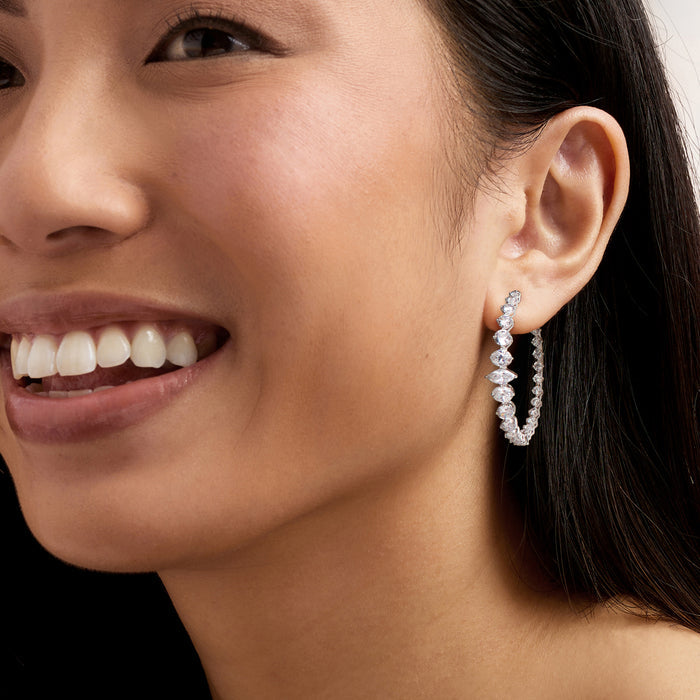 Rhodium-plated hoop earrings with clear CZ stones worn by model