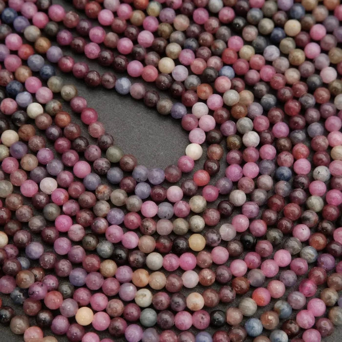 Close-up of multicolored round beads on a dark background