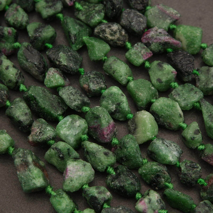 Close-up of green and black stones on a dark surface