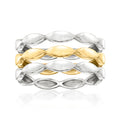 Three wave rings in silver and gold-tone metal, polished oval links in a stack