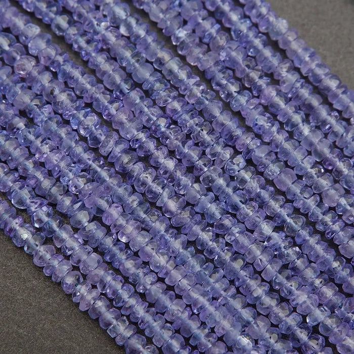 Close-up of a string of purple beads on a dark background